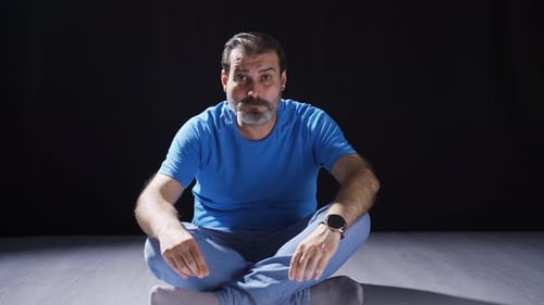 Psychologically troubled man looking strangely at camera.