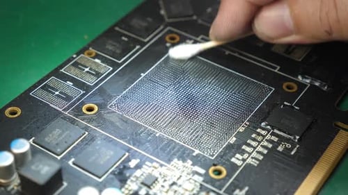 Technician Cleaning Computer Motherboard with Cotton Swab