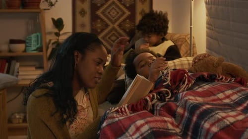 Family Reading Bedtime Story at Night