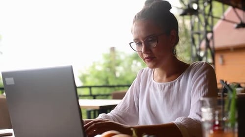 Young Mixed Race Woman Working with Laptop in Cafe at Tropical Location Asian Caucasian Female