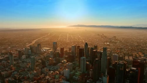 Golden hour in Los Angeles, California, the USA. Uptown is covered with haze at backdrop. Top view.