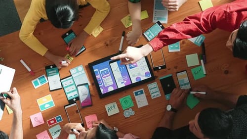 Top view designer present Ux Ui mobile phone interface at meeting. Convocation.
