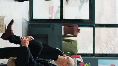 Older Businessman Tying Shoes in a Modern Office