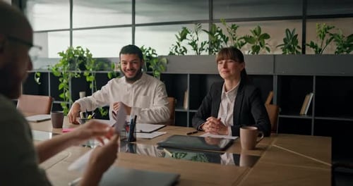 Business Meeting at Conference Table in Modern Office