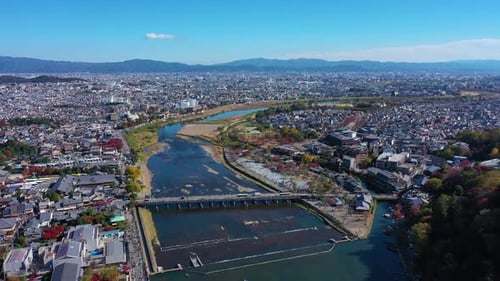 Aerial view 4k by drone of Katsura river and building at autumn and boats. Arashiyama, Kyoto, Japan.