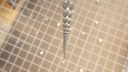 Large Number of Chained Hooks are Raised by Motorized Hoists