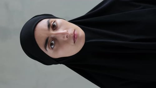 Woman in Black Head Covering Opens Her Eyes