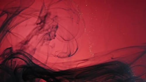 Abstract Black Ink Swirls in Red Water