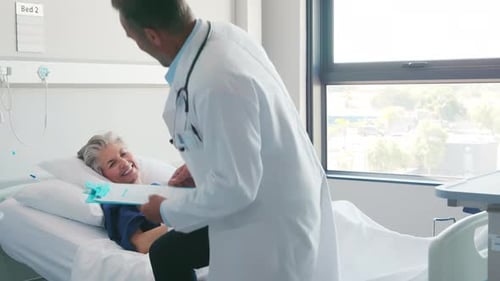 Doctor Assuring Senior Woman Patient Lying On Hospital Bed. Physician Examining Hospitalized Matu...