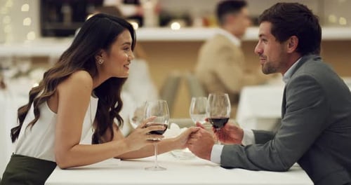 4k video footage of a happy young couple having a romantic date at a fancy restaurant