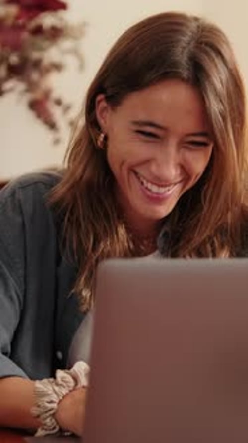 Vertical video, Happy woman distance learning online and working on laptop in living room