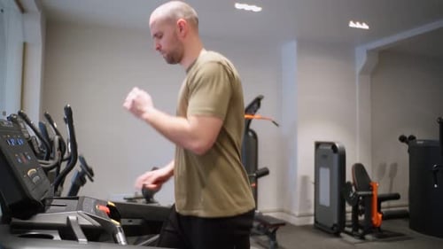 Man Running in the Gym on a Treadmill Concept for Sports Fitness