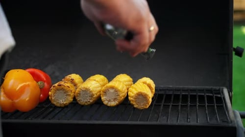 Cook Turns Corn on the Cob on an Outdoor Grill It's Party Time and the Vegetables are Grilling