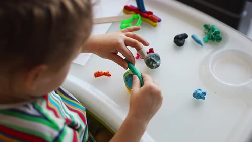 Child Creative with Colorful Modeling Clay at Home