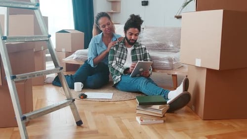 Happy Couple in New Home with Moving Boxes