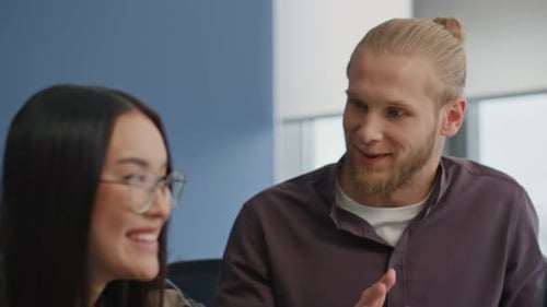 Enthusiastic Colleagues Give High Five in Modern Office
