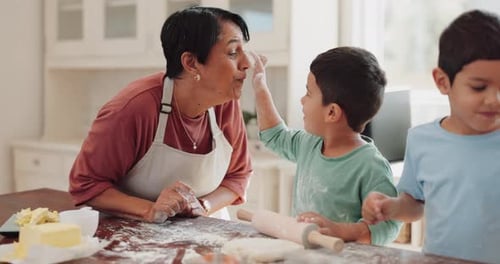 Woman and Two Children Baking in Kitchen