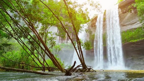 A majestic waterfall cascades from a towering cliff.
