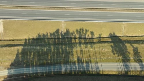 Aerial top down - Shadows of trees cast over a highwa