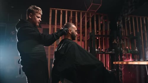 Barber Giving Haircut in Dark Modern Barbershop