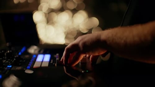 DJ Mixing Music with a Sound Board