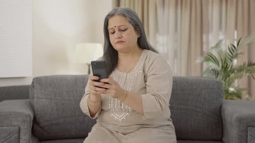 Indian old woman texting someone