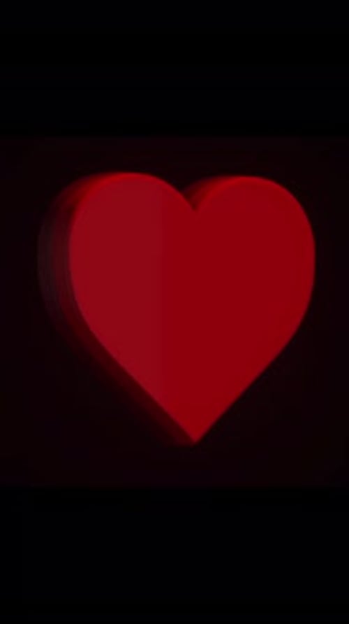 Animation eines rotierenden roten Herzens auf schwarzem Hintergrund Konzept der Liebe
