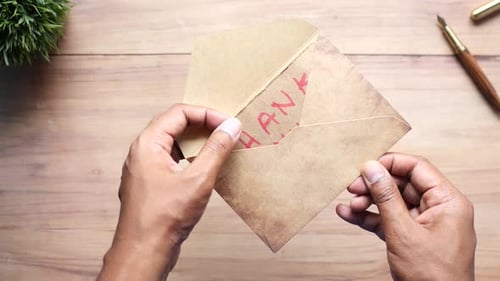 Close Up of Man Hand Reading a Thank you Letter