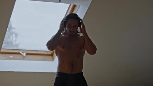 Man Listening to Music With Headphones Indoors