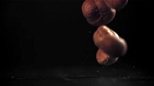 Peeled Hazelnuts Falling in Slow Motion