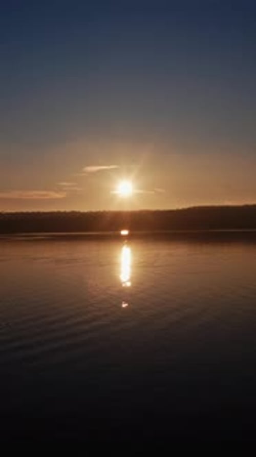 Aerial view of forest and river during sunset. Forest landscape sunset over water