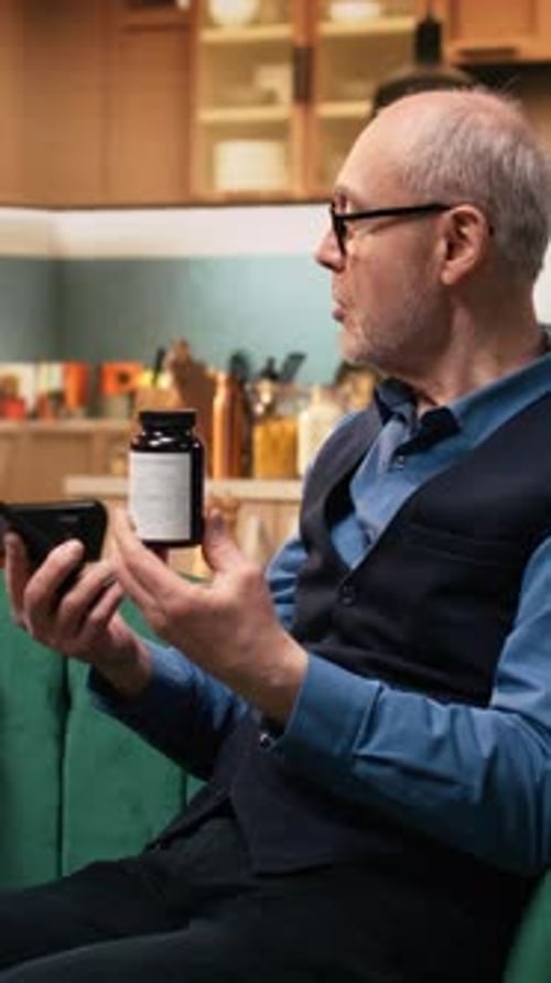 Vertical Video Aged Senior Man Reading Pill Box Labels and Supplements for Medical Routine
