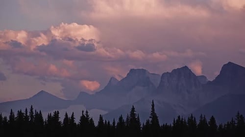 Dramatic Sunset Over Mountains and Forest Landscape
