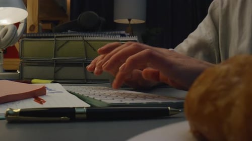 Woman Types on Keyboard While at Her Desk