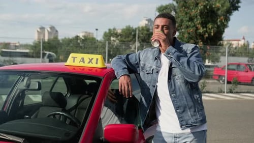 Taxi Driver Smiling and Drinking Coffee in City