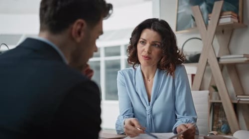 Businesswoman Conducting Job Interview with Elegant Man at Office Desk Closeup