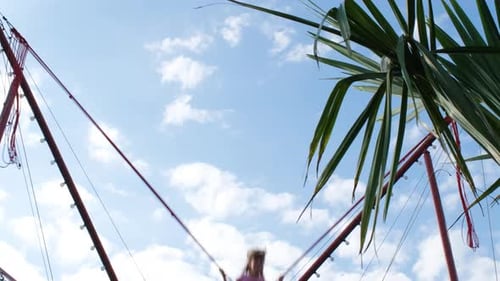 Little Girl Jumping High on Bungee Attraction