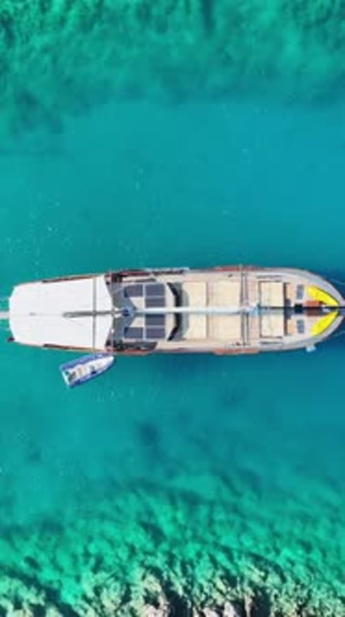 Aerial view: Boat sailing through turquoise waters channel