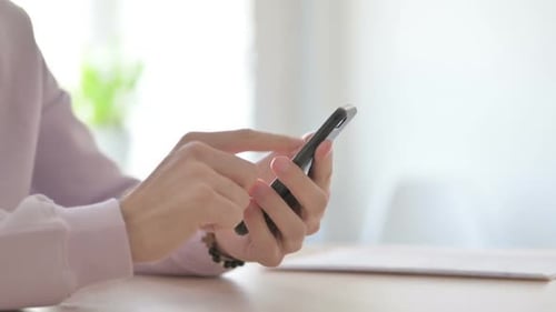 Close Up of Man Browsing Internet on Smartphone
