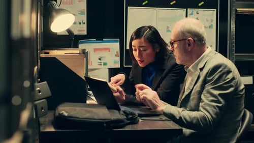 Office Teamwork on Project with Laptop and Notebook