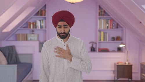 Man Coughing, Rubbing Chest Indoors