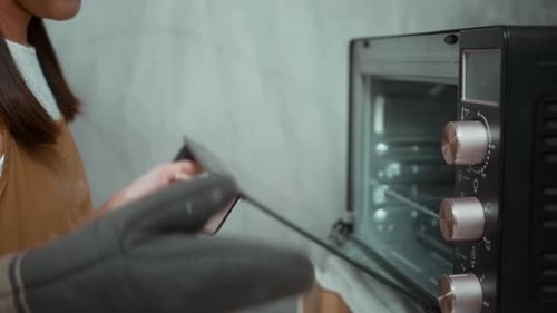 Young beautiful woman is baking in her kitchen