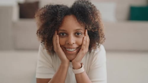 Smiling Woman Poses in Bright Room with Braces