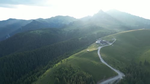 Aerial View of Green Mountains and Rural Road