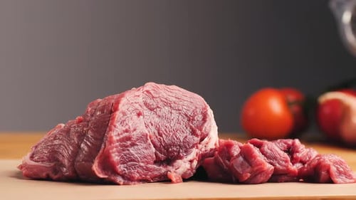 Fresh Raw Beef and Tomatoes on Wooden Board