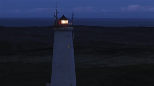 Lighthouse with Light Beam at Night