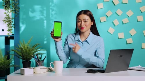 Employee Holding Phone with Green Screen