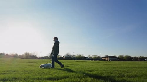 A Woman Slow Walking with Her Dog in the Park Wide Slow Motion
