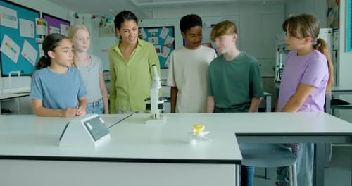 Kids Learning Science in Classroom Using Microscope