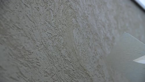 Worker Applies Textures Stucco with Putty on Wall in Room